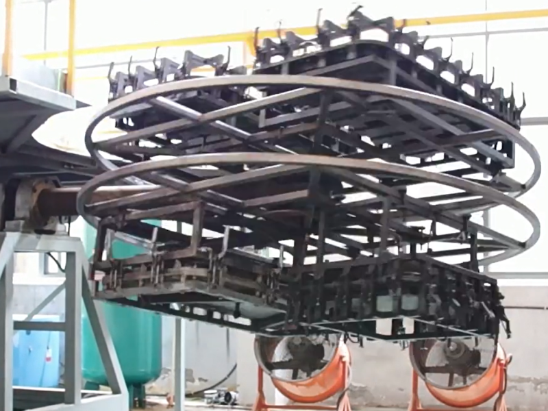 Rotational molding machine forming large plastic containers with multi-station tooling system