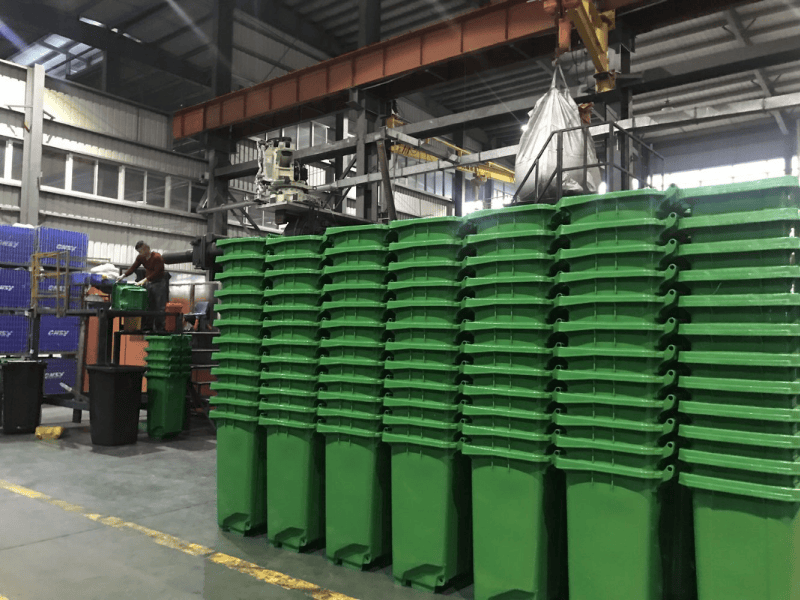 green plastic waste bin are stacked together in the factory