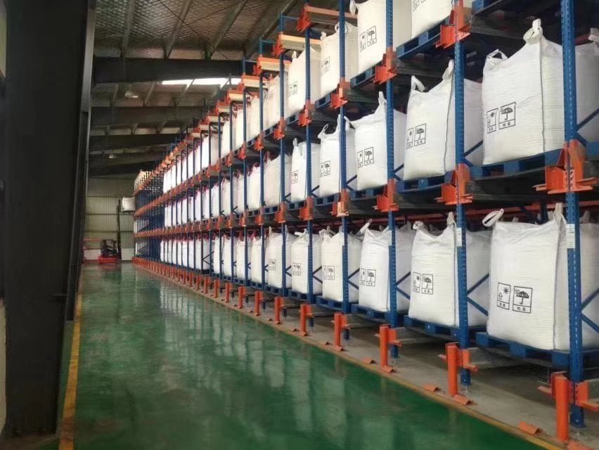 Heavy duty plastic pallets supporting heavy loads in warehouse racking system